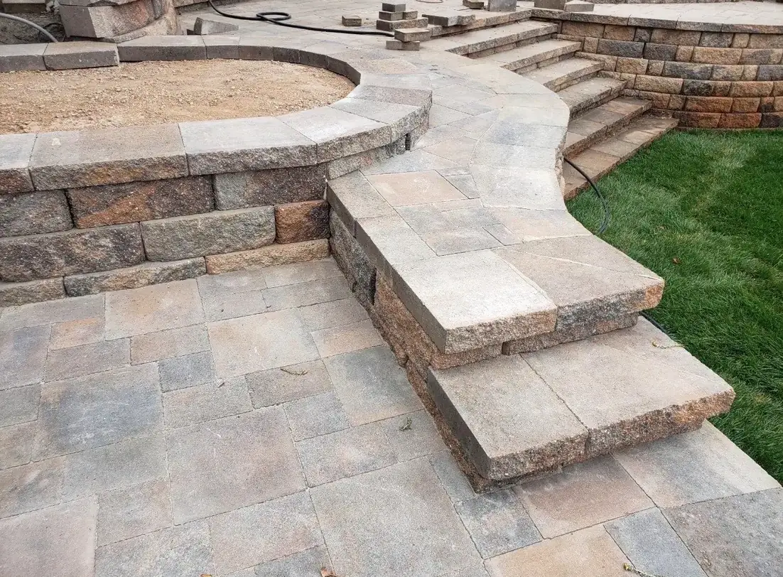 Stone paver patio with steps and fire pit area